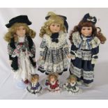3 collectors dolls on stands with 3 miniature dolls