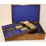 Oak cased part canteen of Walker & Hall silver plated rat tail cutlery