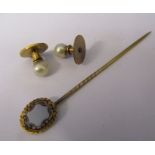 Pair of yellow metal and pearl dress studs and a yellow metal stick pin