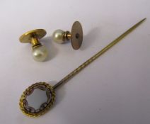 Pair of yellow metal and pearl dress studs and a yellow metal stick pin