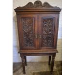 Late 19th century carved oak cabinet on stand Ht 156cm W 80cm D 45cm