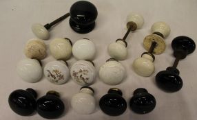 A quantity of 19th / 20th century ceramic door knobs in black and cream