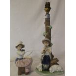 Nao seated girl holding a dog & figural table lamp boy with sheep