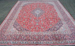 Large red ground Iranian Kashan province carpet with floral pattern  3.86m by 2.97m