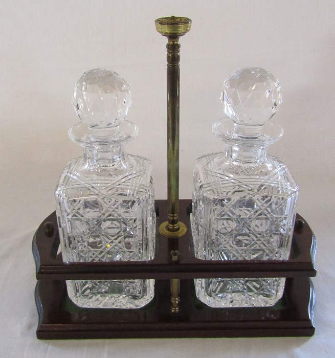 Pair of cut glass decanters on a wooden stand