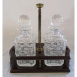 Pair of cut glass decanters on a wooden stand