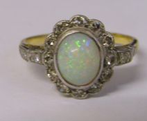 18ct gold and platinum ring with central opal and diamond chips (diamond total 0.25 ct) total weight