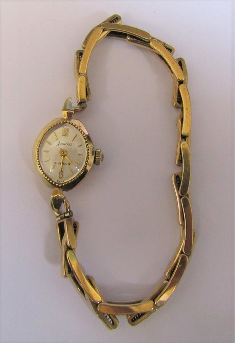 9ct gold ladies Accurist 21 jewel wrist watch with 9ct gold elasticated strap, weight excluding