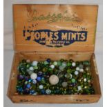 Wooden box containing a quantity of old marbles