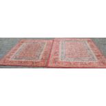 Pair of red ground rugs 237cm by 170cm & 198cm by 141cm