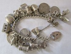 Silver charm bracelet with assorted charms and coins total weight 2.67 ozt