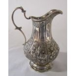 Ornate Victorian silver jug embossed with Chinese characters inc man, dragon and flowers etc,