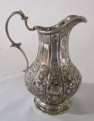 Ornate Victorian silver jug embossed with Chinese characters inc man, dragon and flowers etc,