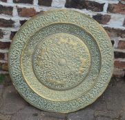 Large heavily embossed brass charger / table top