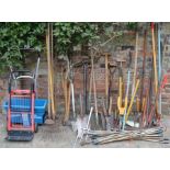 Large quantity of gardening tools, fertilizer spreader & a sack barrow
