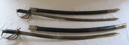 2 dress swords with curved blades and scabbards