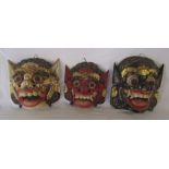 3 wooden painted tribal style masks H 27 cm and 26 cm