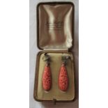 Pair of sterling silver carved coral drop earrings (length of coral 43 mm) total drop 5 cm total