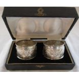 Boxed pair of napkins rings decorated with palm trees etc marked sterling silver weight 1.01 ozt