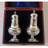 Boxed pair of Victorian silver pepper pots Birmingham 1897 (both slightly mis-shapen) weight 2.11