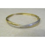 9ct gold bangle, two tone effect with cubic zirconia accents total weight 6.4 g