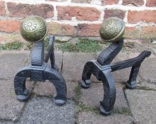 Pair of cast iron and brass fire dogs