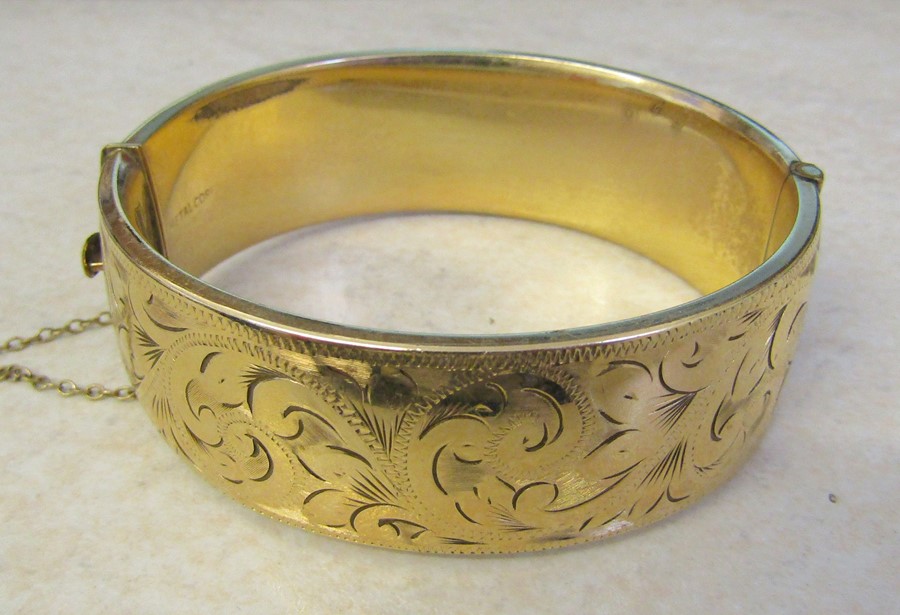 9ct gold bangle with metal core (1/5 9ct gold) total weight 52.8 g