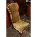 Victorian nursing chair with ornately carved frame