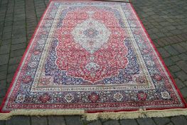 Red ground cashmere carpet with traditional floral pattern approx 308cm by 195cm