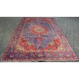 Red & blue ground Persian Trabiz carpet approx 318cm by 205cm with small hole