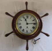 Brass bulkhead clock in ships wheel frame reputedly removed from HMS Ajax with key H 49 cm L 39 cm