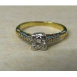 18ct gold and platinum diamond solitaire ring with diamond accents to shoulders approximately 0.25