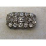 Broken clasp containing approximately 0.45 ct of diamonds (16 mm x 10 mm)