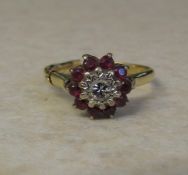 18ct gold ruby and diamond cluster ring (central diamond 0.10 ct) size P weight 4.3 g