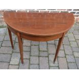 Edwardian mahogany circular foldover card table on square tapered legs