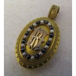 Tested as 14 ct gold ornate monogrammed locket with seed pearls and tigers eye stones total weight