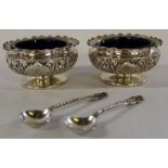 Pair of silver salts with frilled rim, embossed floral decoration and blue glass liners Chester 1898