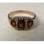 9ct gold garnet trilogy ring with diamond accents weight 2.4 g size M/N