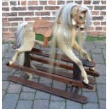Painted rocking horse mounted on a pine treadle base with leather & metal studded saddle with a