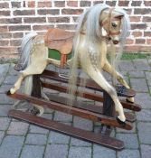 Painted rocking horse mounted on a pine treadle base with leather & metal studded saddle with a