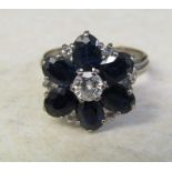 Tested as 9ct white gold diamond and sapphire flower ring, central diamond 0.25 ct, size M, total