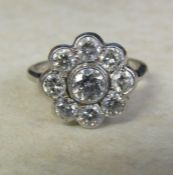 18ct white gold diamond daisy cluster ring, 1.5 ct total (central stone 0.50 ct), size M/N total