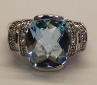 Silver dress ring set with central blue topaz marked 925 size N