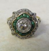 Tested as 18ct gold, emerald and diamond cluster ring, central diamond 1 ct, total weight 4.9 g,