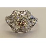 Tested as platinum vintage style diamond cluster ring set with central brilliant cut diamond