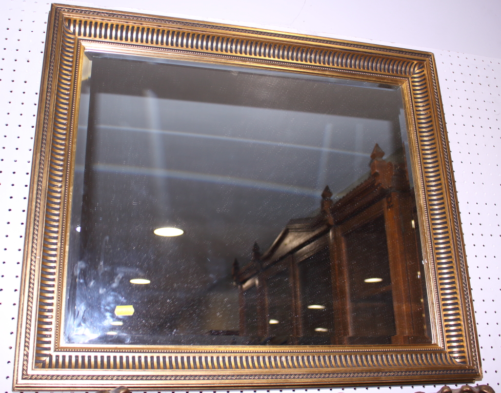 A rectangular gilt framed wall mirror with bevelled plate, 26" x 22"