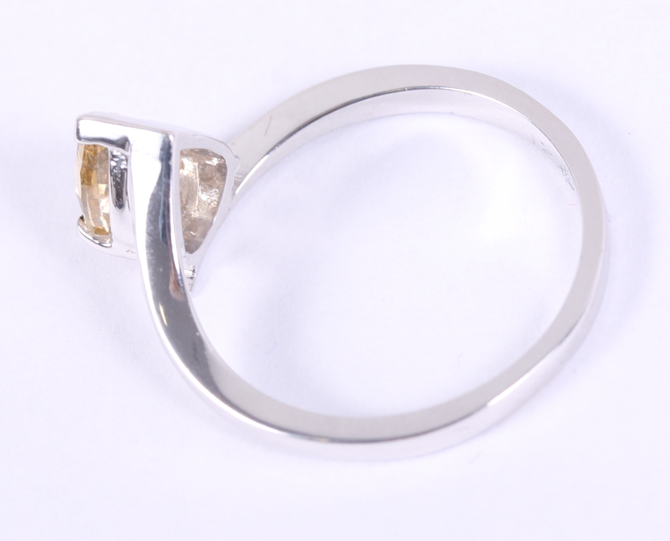A pale brown pear-shaped solitaire diamond ring on cross-over shank, 0.9ct, size L 1/2, - Image 3 of 4