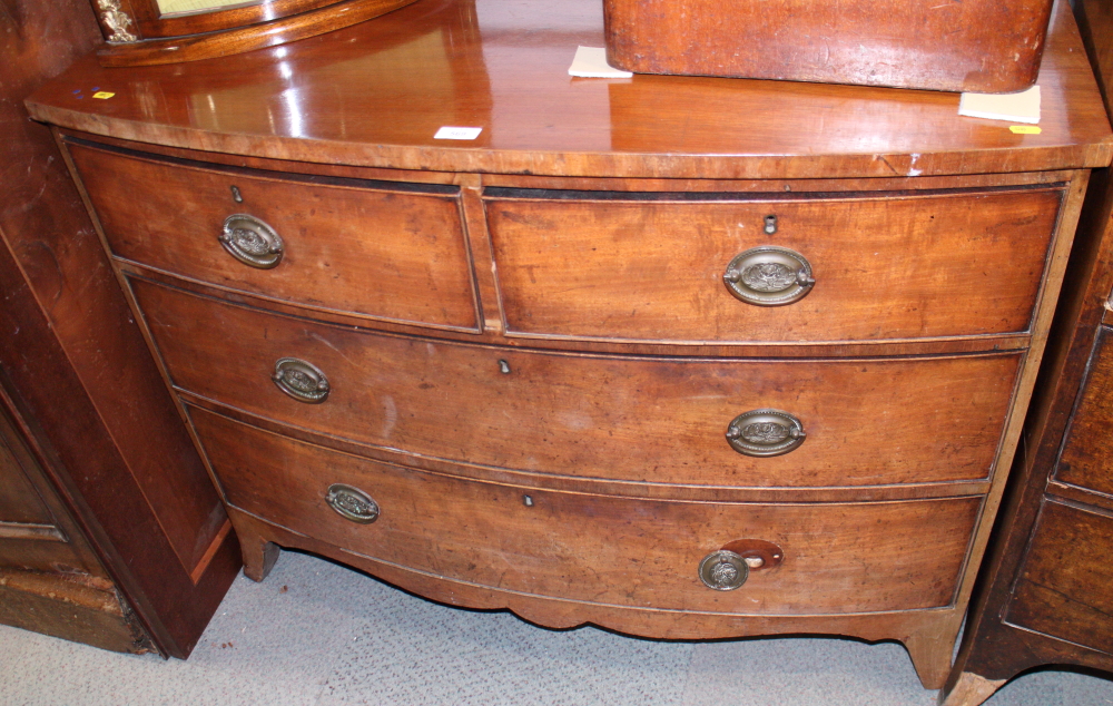 A mahogany bowfront chest of two short and two long drawers with oval handle plates, on bracket