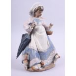 A Lladro gres figure of a girl with cats and an umbrella, 2219, 11" high