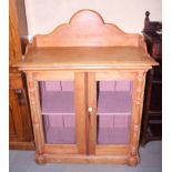 A 19th century Continental pine tray top side cabinet enclosed glazed doors, on block base, 40"